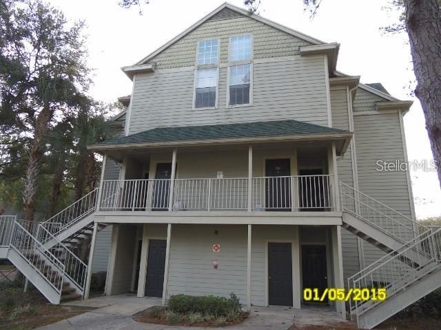A narrow entryway with tile flooring, a white front door, and two closet doors — 5962 WESTGATE DRIVE UNIT 204, ORLANDO, FL