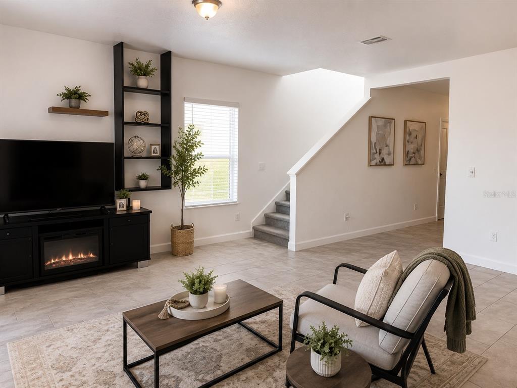 A bathroom with a dark vanity, granite countertop, and an adjacent walk-in closet — 3516 WOODMONT DRIVE, PARRISH, FL