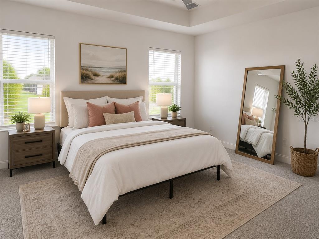 A bedroom features a bed with pink pillows, two windows, and a large floor mirror — 3516 WOODMONT DRIVE, PARRISH, FL