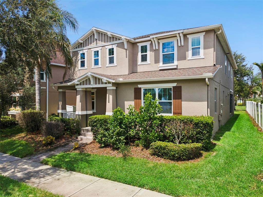An open-concept living area features a kitchen with dark cabinetry, a dining space, and furniture — 14741 SNOWY EGRET STREET, WINTER GARDEN, FL