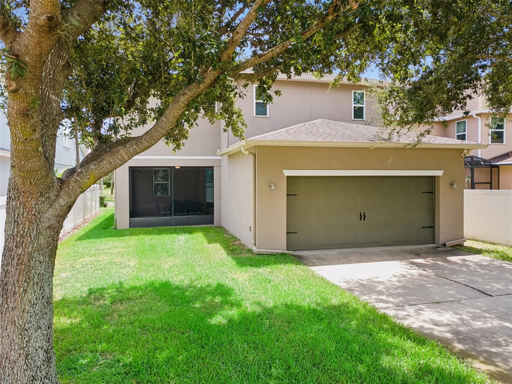 A spacious bedroom features a white bed, a wooden dresser, and a walk-in closet — 14741 SNOWY EGRET STREET, WINTER GARDEN, FL