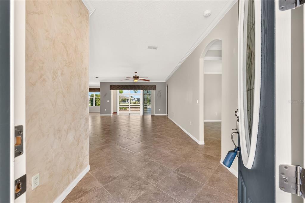 A paved walkway leads to the front entrance of a house with stone siding — 8889 SW 86TH LOOP, OCALA, FL