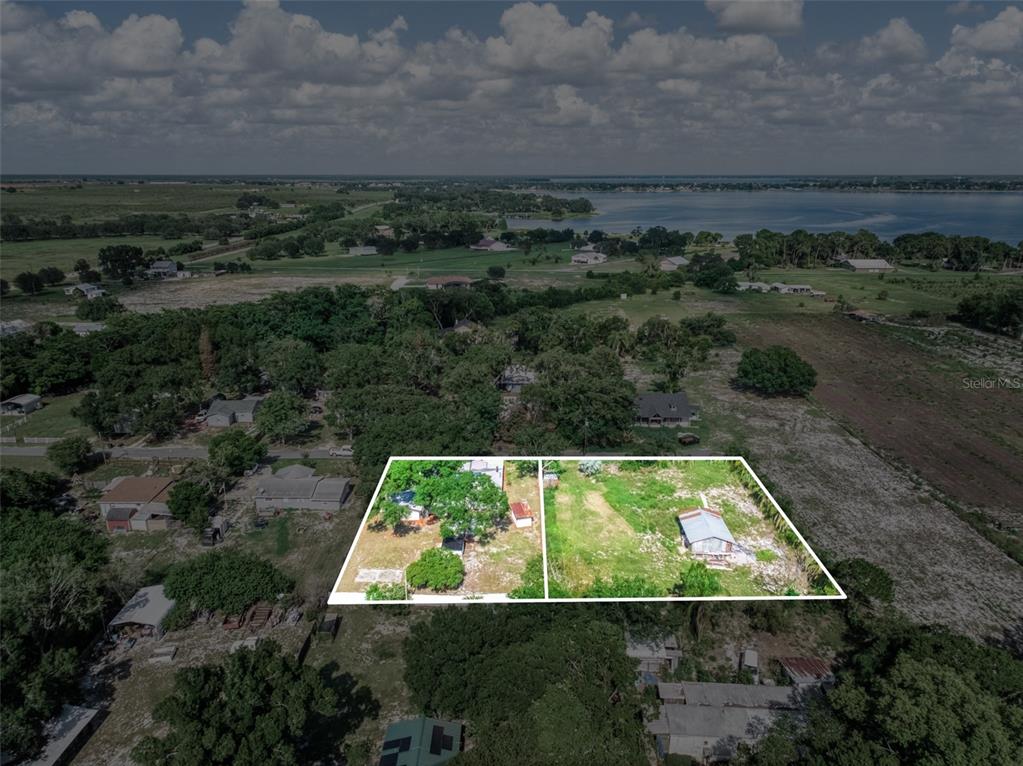An aerial view shows two adjacent rectangular lots with trees and small structures — 201 BROOKS ROAD, FROSTPROOF, FL