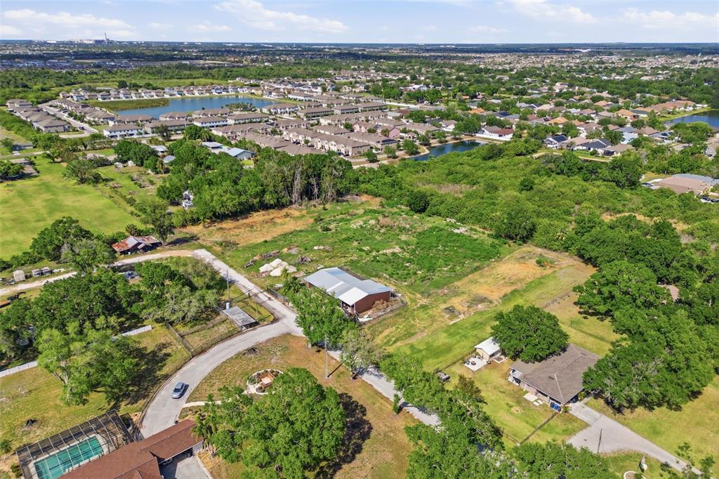 An aerial view shows a residential property with a house, outbuildings, and surrounding green space — SHELL POINT ROAD, RUSKIN, FL