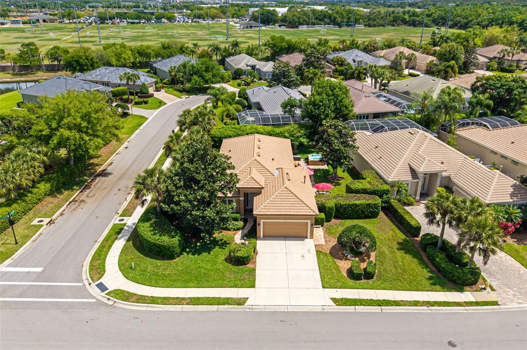 An aerial view of a suburban house with a tile roof and a paved driveway — 5237 97TH STREET E, BRADENTON, FL
