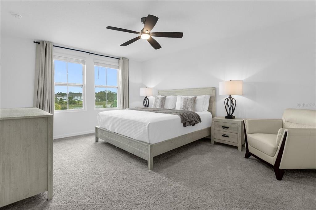 A bedroom features a bed, two nightstands, a chair, and a ceiling fan — 935 CONCH ROAD, DAVENPORT, FL
