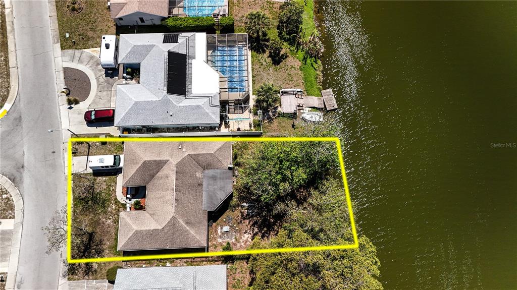 A kitchen features light wood cabinets, stainless steel appliances, and a U-shaped laminate countertop — 7619 VIENNA LANE, PORT RICHEY, FL