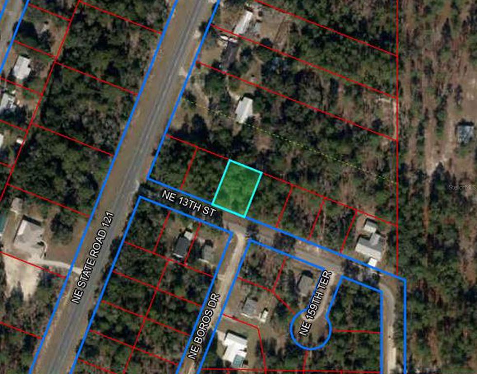 This is an aerial map showing a highlighted parcel of land near a road intersection — 15955 NE 13TH STREET, WILLISTON, FL