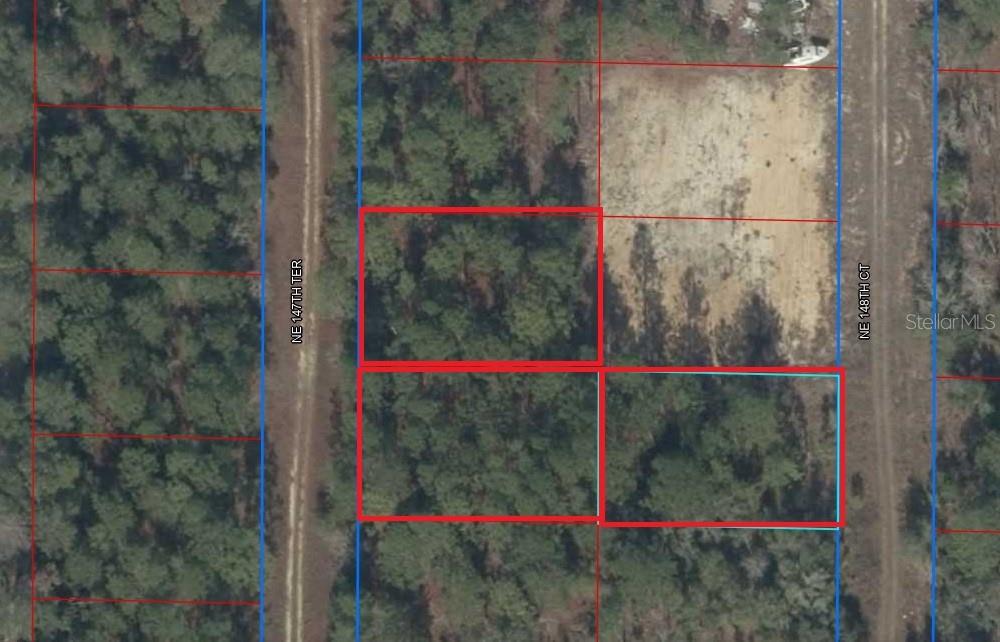 This is an aerial map showing several wooded land parcels outlined in red and blue — TBD NE 148TH COURT, WILLISTON, FL