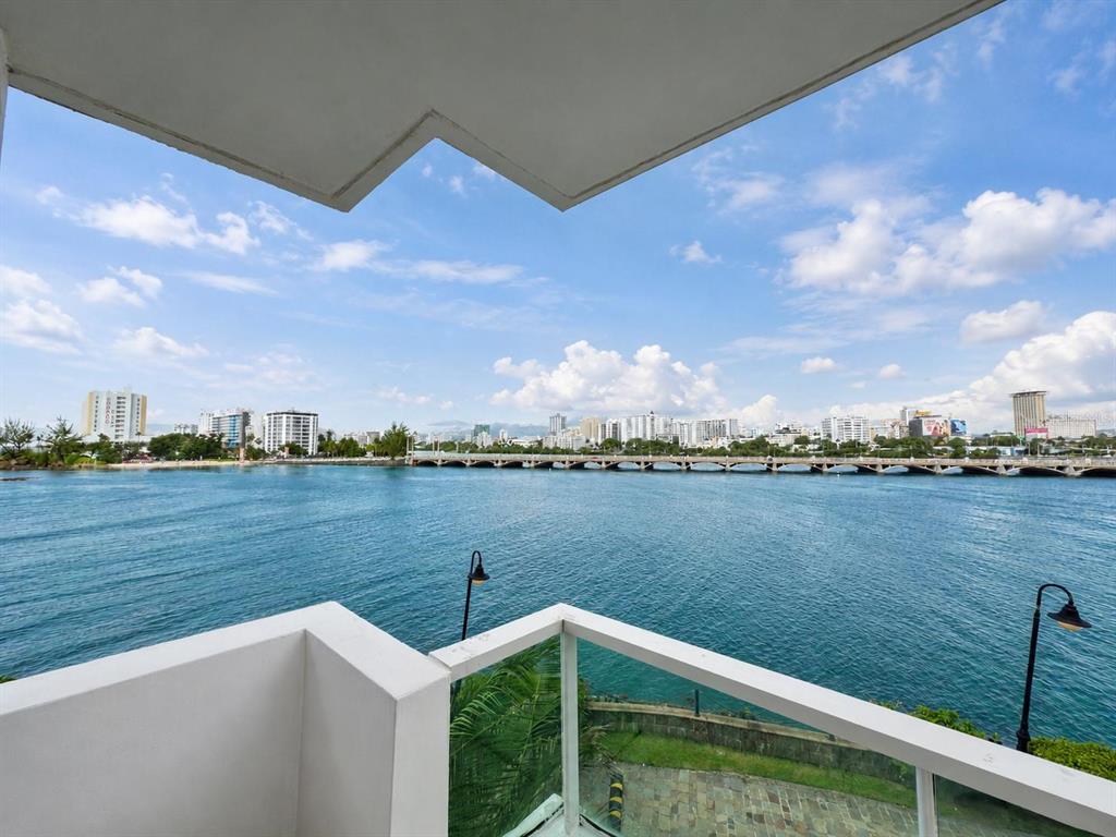 A balcony view overlooking a body of water with a city skyline in the distance — 1 CALLE SAN GERONIMO UNIT 319, SAN JUAN, PR