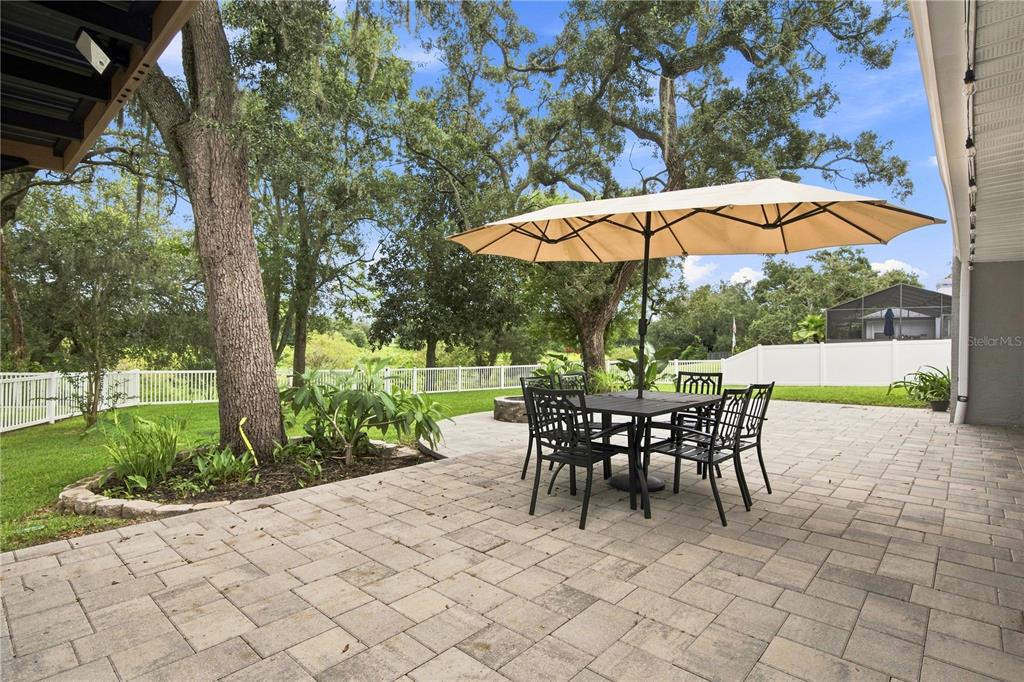 A single-story house with a gray exterior, a white garage door, and a front lawn — 8345 APPLE ORCHARD ROAD, SPRING HILL, FL