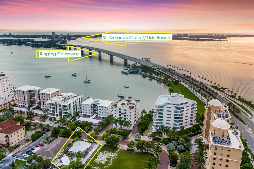 An aerial view shows a coastal neighborhood, the Ringling Causeway, and the surrounding bay area — 161 GOLDEN GATE POINT, SARASOTA, FL