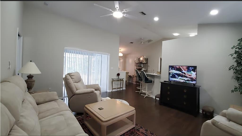 A living room features a beige sofa, a recliner, a coffee table, and a television — 2534 N BRENTWOOD CIRCLE, LECANTO, FL