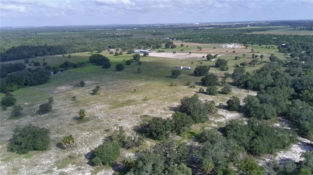 An aerial view shows a large, grassy rural property with scattered trees and small structures — 4547 GLEN SAINT MARY RD ROAD, LAKE WALES, FL