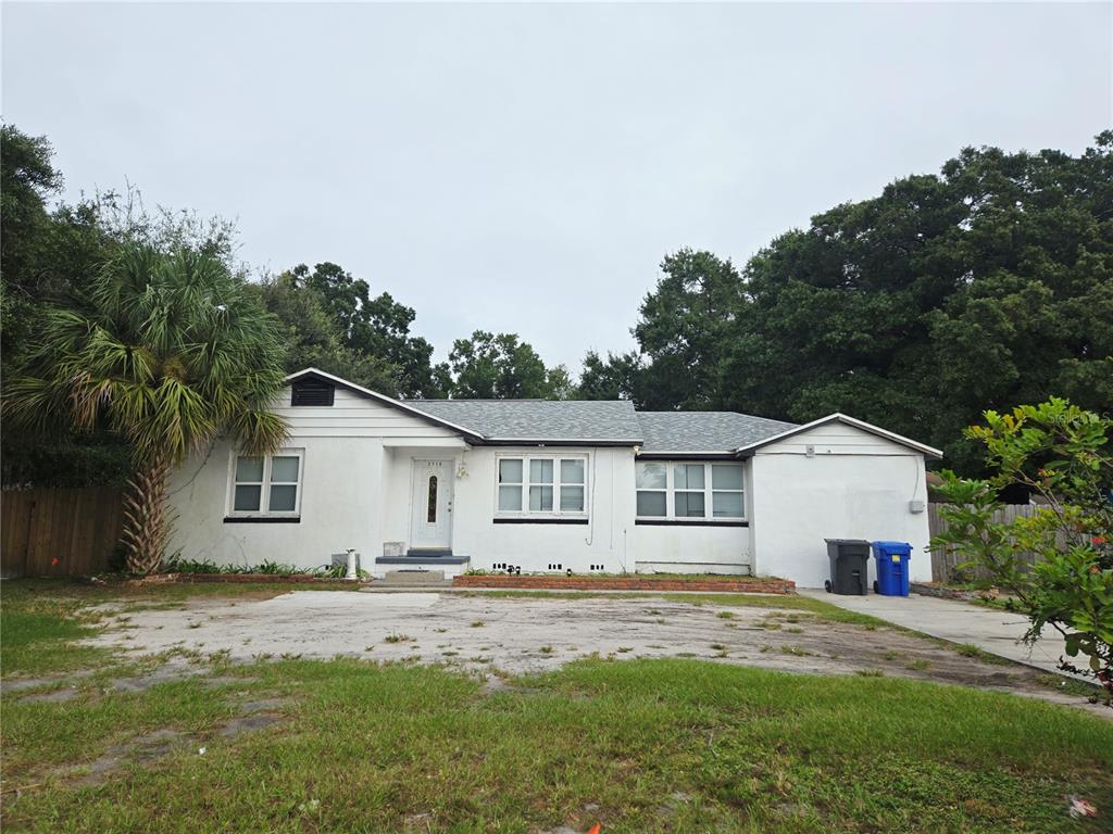 A single-story white house with a gray shingled roof and a large front yard — 3119 W LAMBRIGHT STREET, TAMPA, FL
