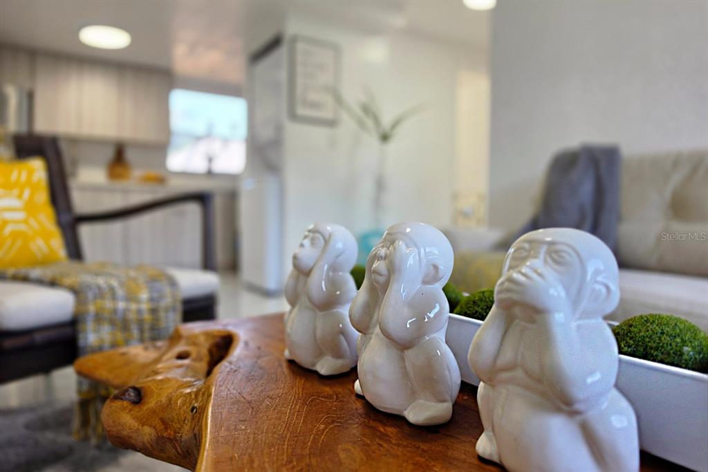 Three white monkey figurines sit on a wooden coffee table in a living room — 431 N EAST AVENUE, SARASOTA, FL