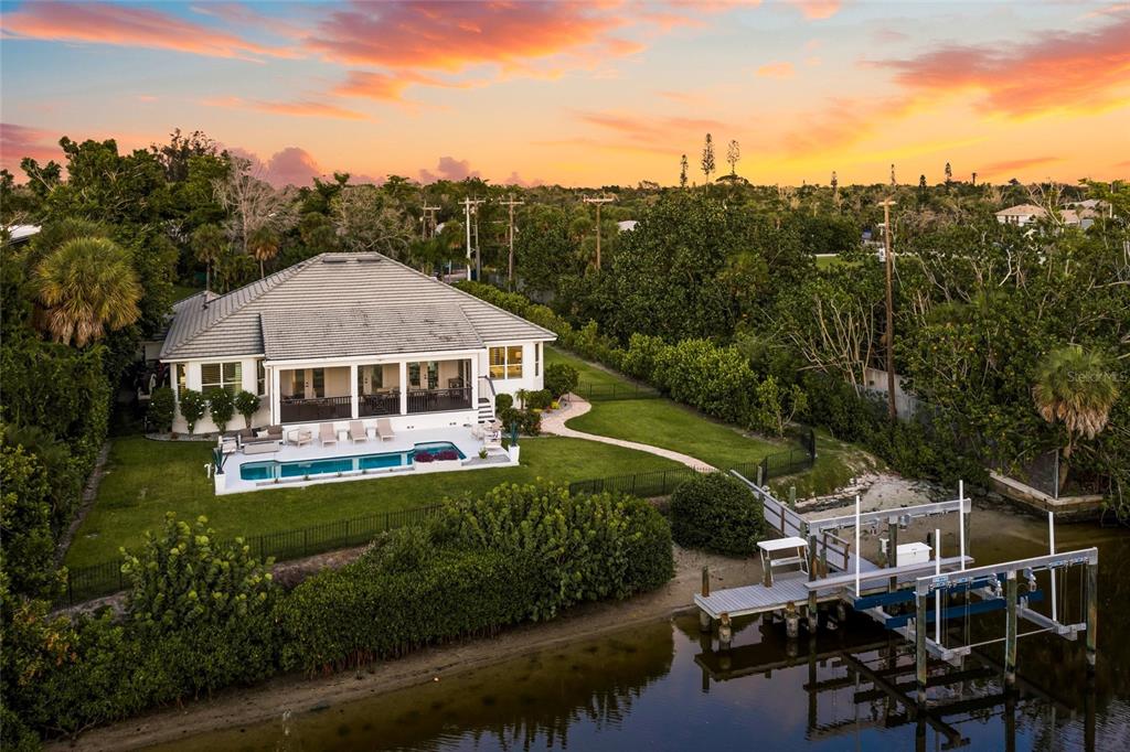 An aerial view of a waterfront house with a swimming pool and a private boat dock — 5178 OAKMONT PLACE, SARASOTA, FL