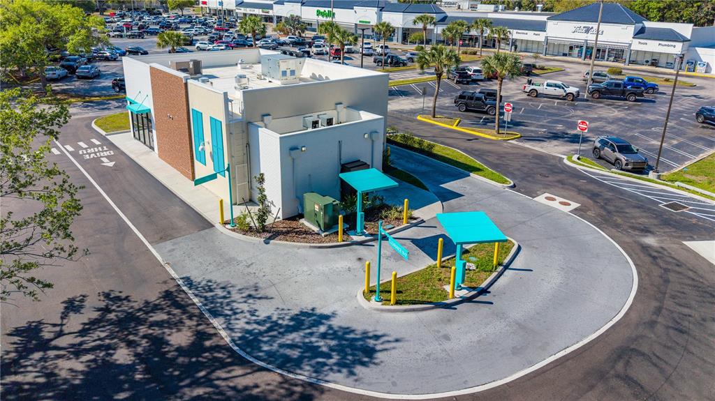 An aerial view shows a commercial building with a drive-thru lane and parking lot — 2900 S RIDGEWOOD AVENUE, EDGEWATER, FL