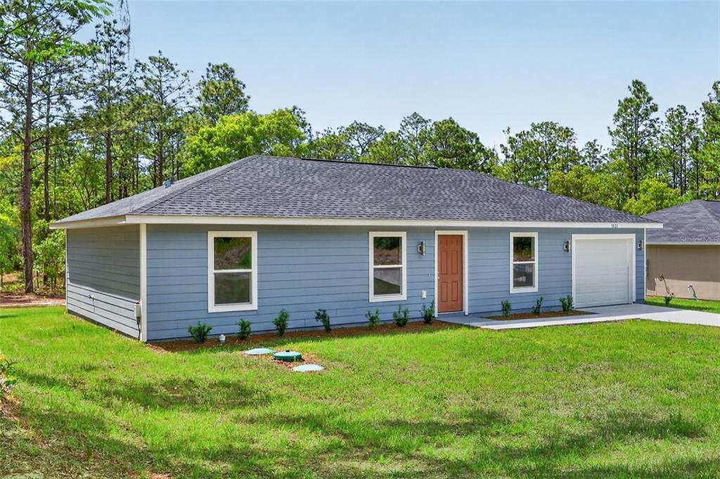 A single-story house with blue siding, a brown front door, and a white garage door — TBD SW 30TH STREET, OCALA, FL