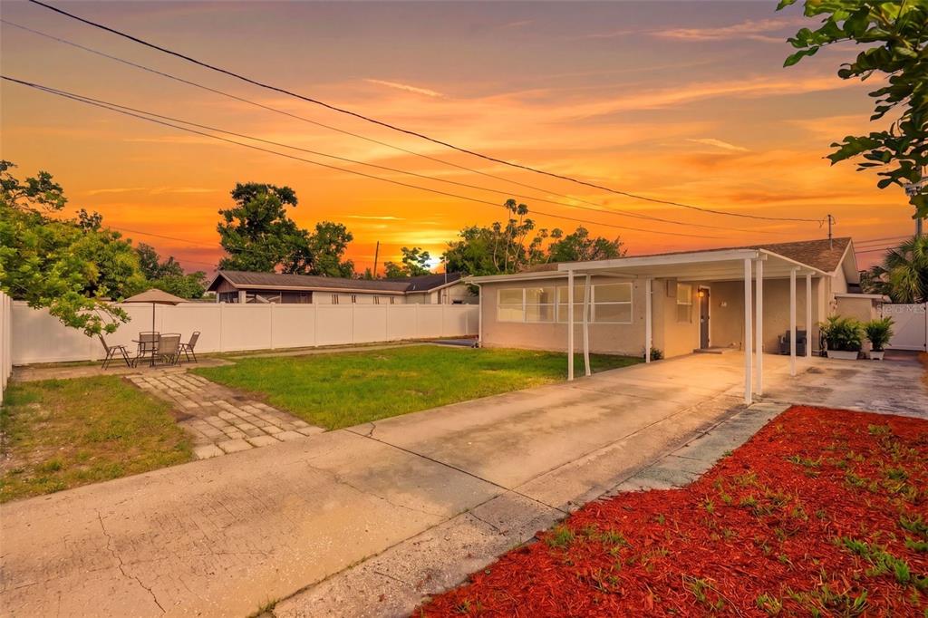 A single-story house with a tan exterior, a brown roof, and a concrete walkway — 4075 38TH AVENUE N, ST PETERSBURG, FL