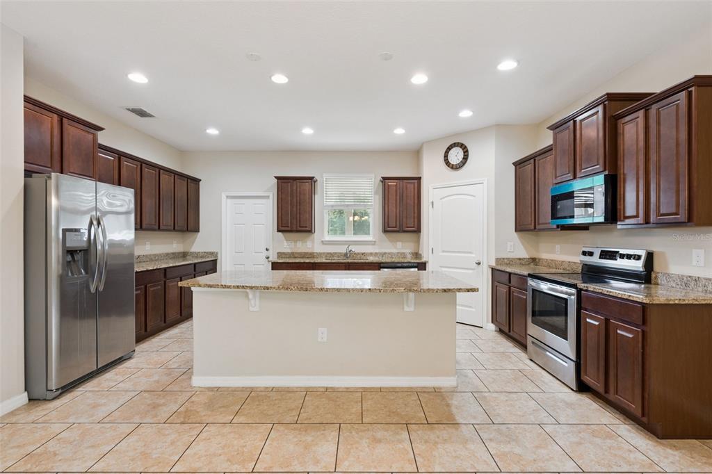 An entryway features tiled floors, a high ceiling, and a white front door with sidelights — 2230 J LAWSON BOULEVARD, ORLANDO, FL