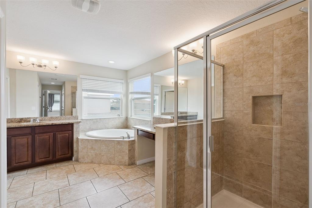 A tiled entryway leads into a carpeted living room through a wide arched doorway — 2230 J LAWSON BOULEVARD, ORLANDO, FL