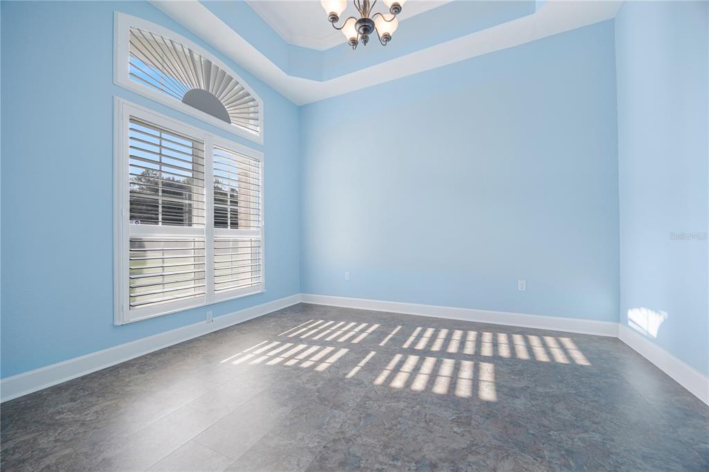 A bright entryway with light blue walls, white double doors, and a dining area — 254 SW NIGHTSHADE DRIVE, LAKE CITY, FL