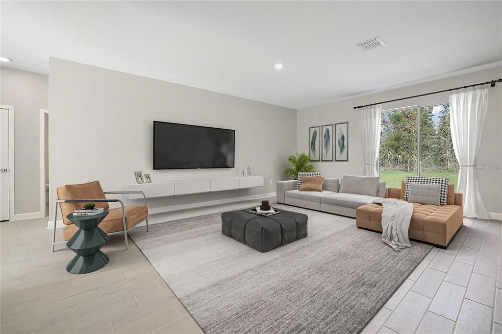 A modern living room features a floating media console, a large sectional, and tile flooring — 5454 RHAPSODY AVENUE, NORTH PORT, FL