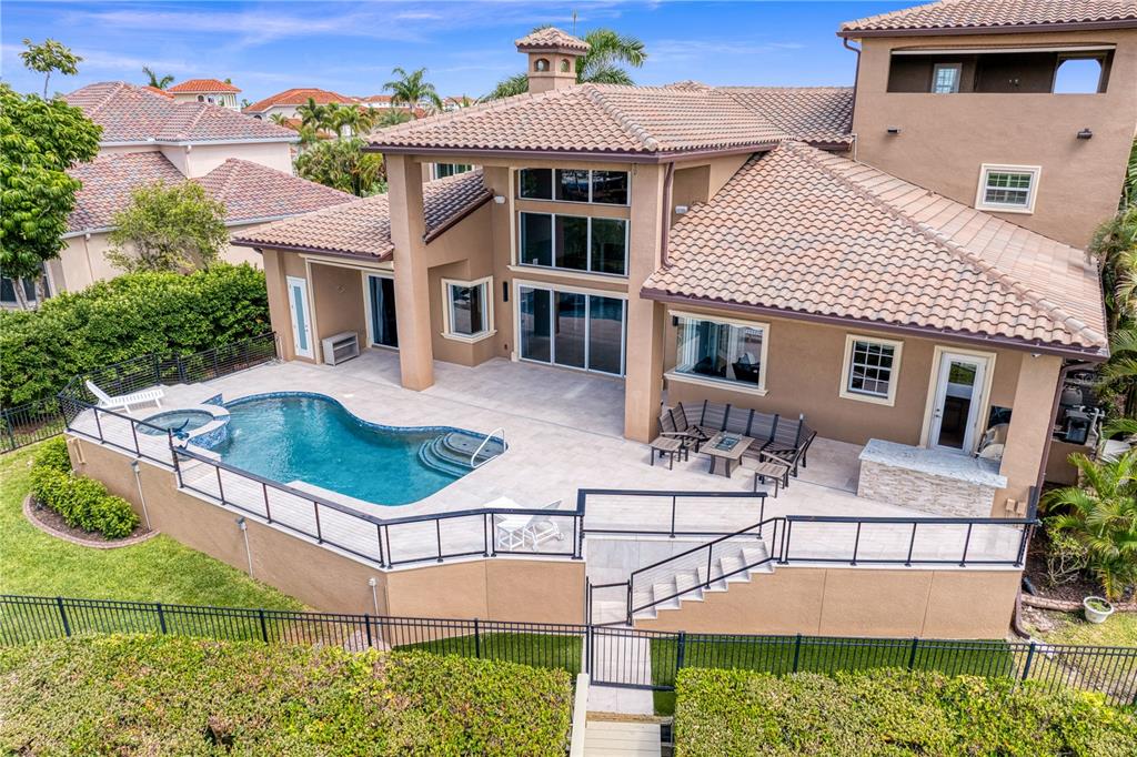 An aerial view of a house exterior featuring a swimming pool and patio area — 6459 RUBIA CIRCLE, APOLLO BEACH, FL