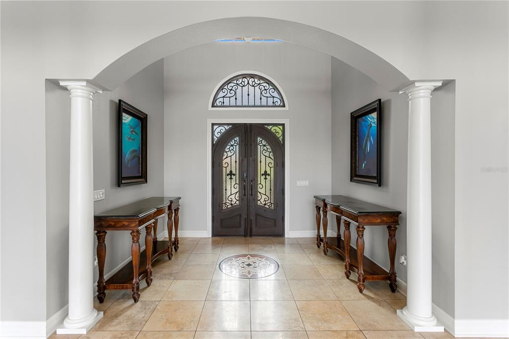 An entryway features a tiled floor, two console tables, and a double door with an arch — 6459 RUBIA CIRCLE, APOLLO BEACH, FL