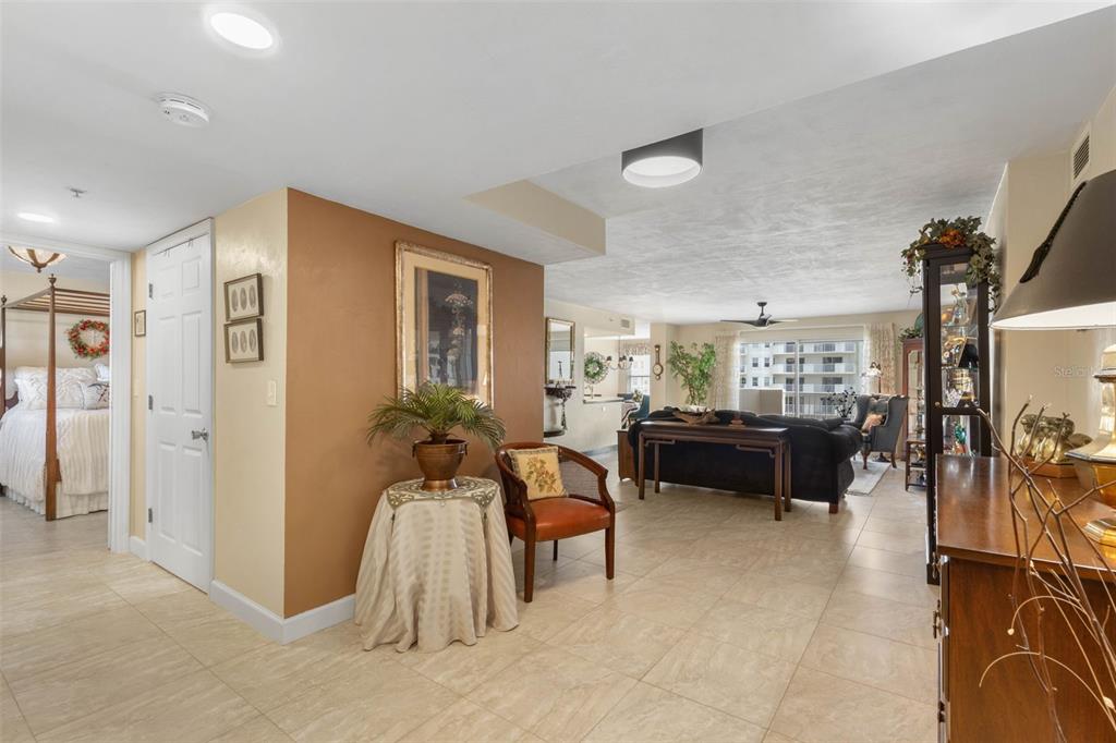 A tiled entryway leads into a living room with a brown accent wall and furniture — 1 JOHN ANDERSON DRIVE UNIT 5160, ORMOND BEACH, FL