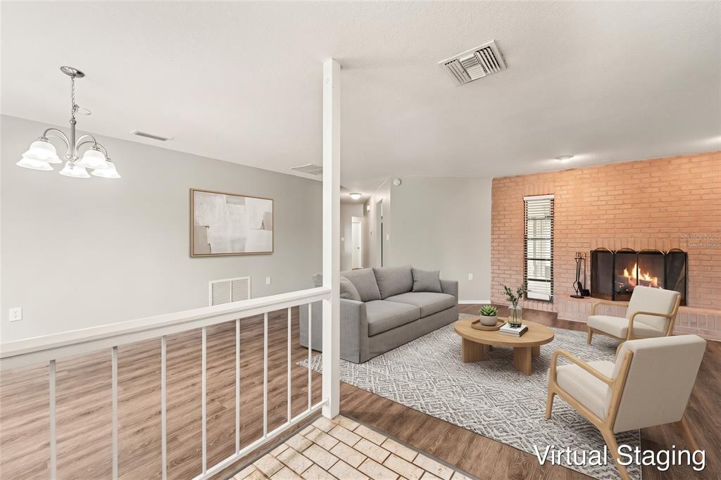 A living room features wood-look flooring, a brick fireplace, and a white metal railing — 8321 BRIARLEAF COURT, PORT RICHEY, FL