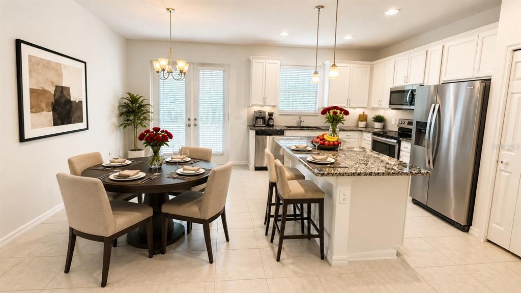A kitchen and dining area featuring white cabinets, stainless steel appliances, and a granite island — 4420 GUMBO LIMBO DRIVE, ORLANDO, FL