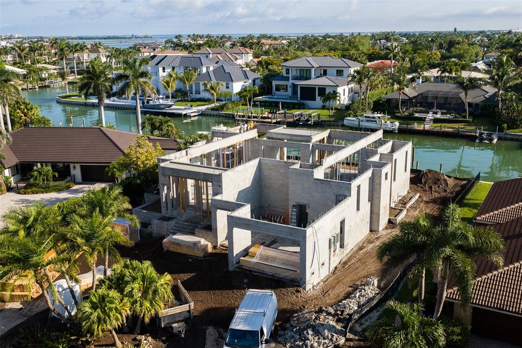 An aerial view of a concrete house under construction located on a waterfront lot — 526 N SPOONBILL DRIVE, SARASOTA, FL