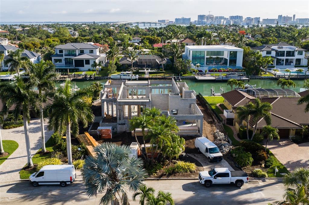 An aerial view shows a concrete residential structure under construction on a waterfront lot — 526 N SPOONBILL DRIVE, SARASOTA, FL