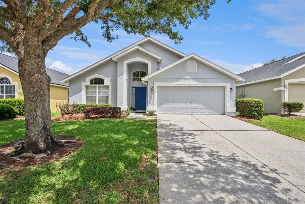 A single-story gray house with a blue front door and a concrete driveway — 5345 LOS PALMA VISTA DRIVE, ORLANDO, FL