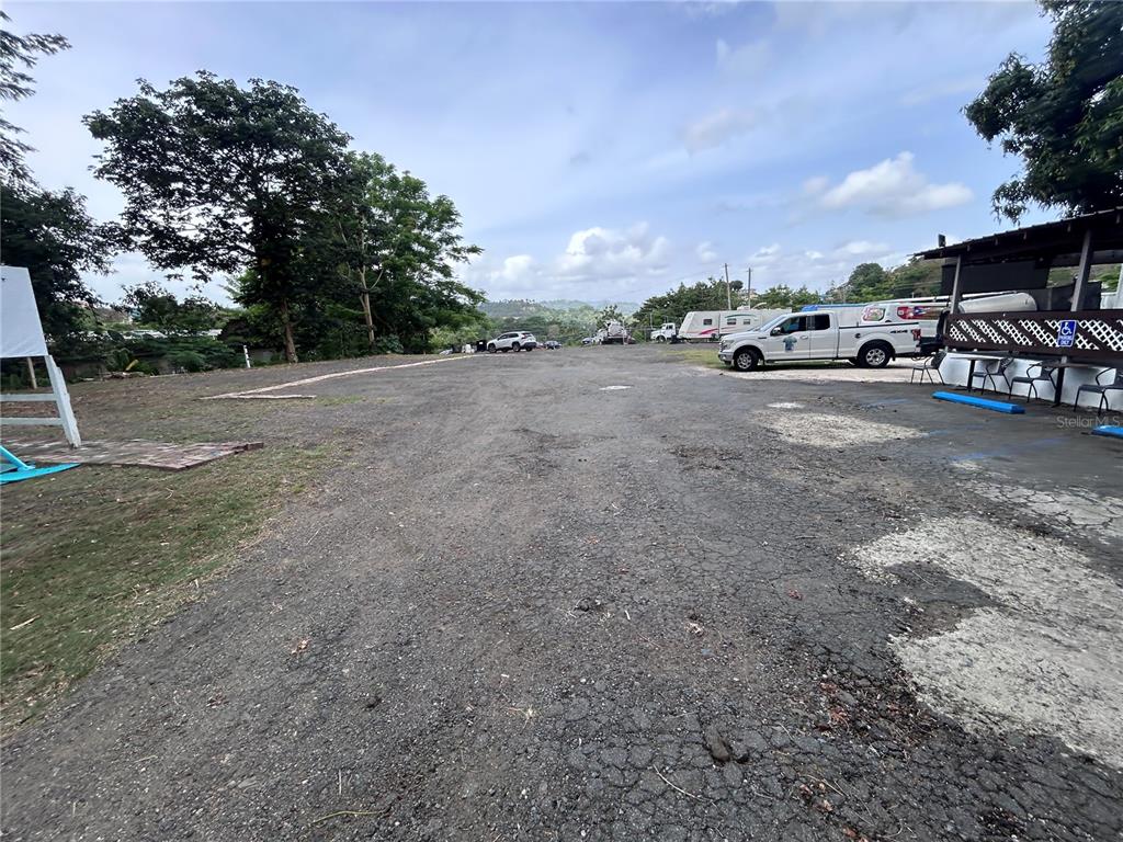A gravel parking lot sits in front of a building with a covered patio area — PR 842 CAIMITO ALTO, SAN JUAN, PR