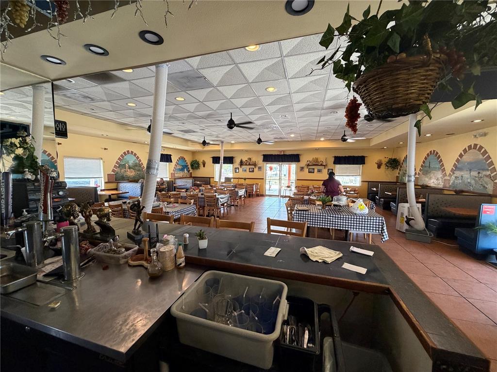 The interior of a restaurant features a bar area, dining tables, and a drop ceiling — 1501 CLEARWATER LARGO ROAD N, LARGO, FL