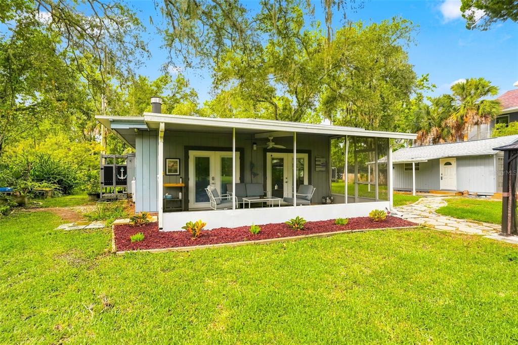 A concrete boat launch area features steps leading into the water with three kayak paddles — 5421 GAY STREET, WEEKI WACHEE, FL