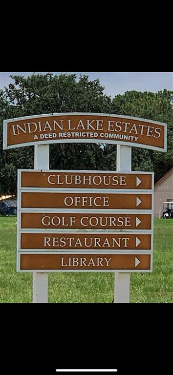 A brown, multi-tiered sign points toward the clubhouse, office, golf course, restaurant, and library — 1014 JAPONICA DRIVE, INDIAN LAKE ESTATES, FL