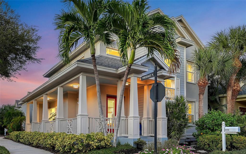 A two-story house with a wrap-around porch, palm trees, and a street sign — 1775 STAPLETON STREET, SARASOTA, FL