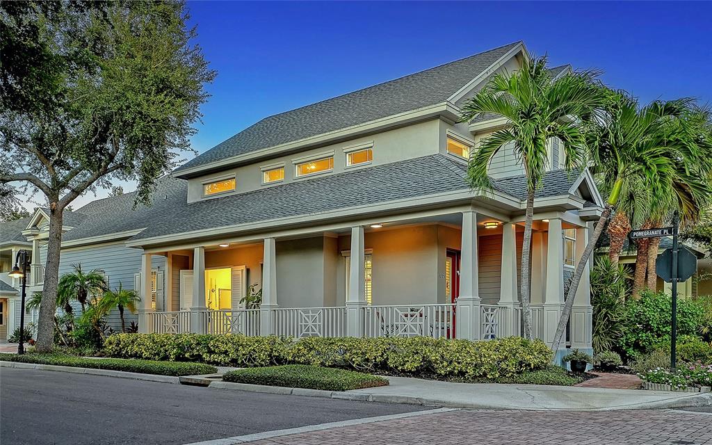 A two-story house with a wrap-around porch, palm trees, and a street sign — 1775 STAPLETON STREET, SARASOTA, FL