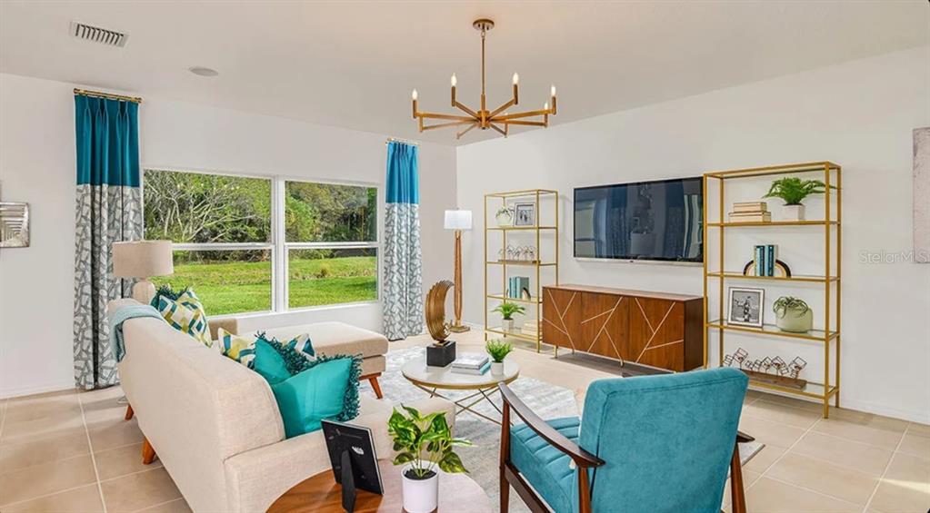 A kitchen and dining area featuring white cabinets, a center island, and a wooden table — 13819 SHELLMORE AVENUE, PALMETTO, FL
