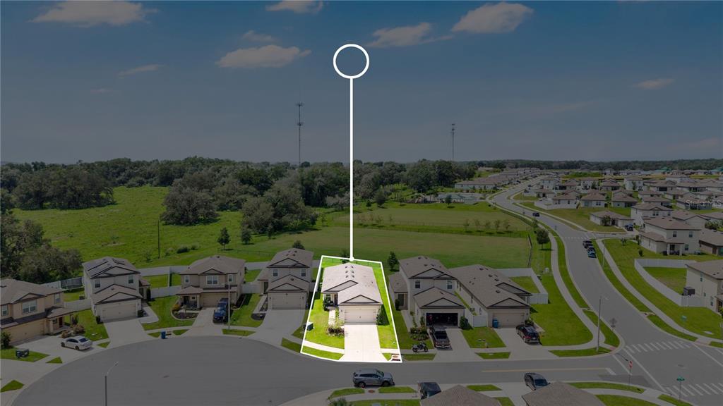 An aerial view shows a single-family house highlighted in a residential neighborhood with green space — 5261 FEZ COURT, BROOKSVILLE, FL