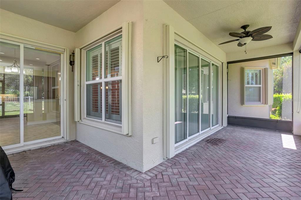 A covered entryway with stone pillars leads to the front doors of a tan building — 16022 GOLDEN LAKES DRIVE, WIMAUMA, FL