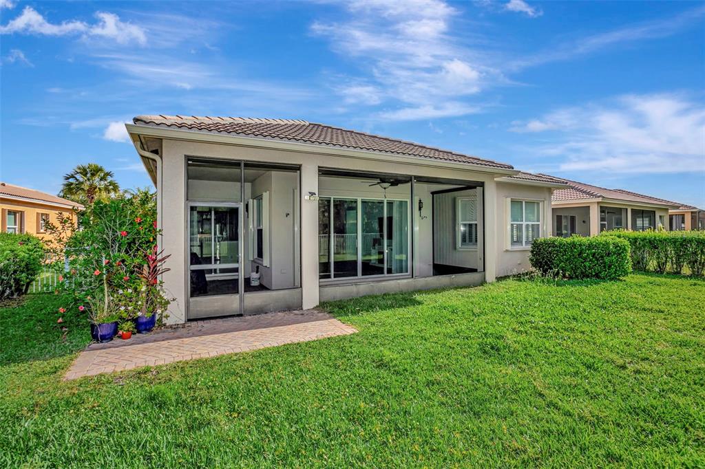 A kitchen features wood cabinets, granite countertops, stainless steel appliances, and tile flooring — 16022 GOLDEN LAKES DRIVE, WIMAUMA, FL