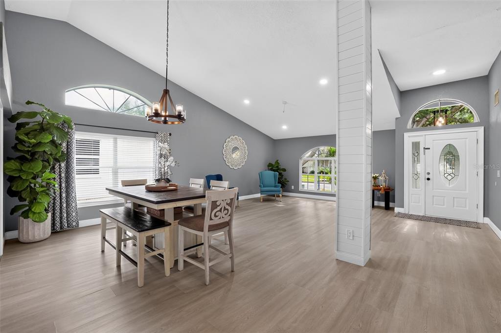 A dining area with a wood table and chairs sits in a room with gray walls — 17721 HAMPSHIRE OAK DRIVE, TAMPA, FL