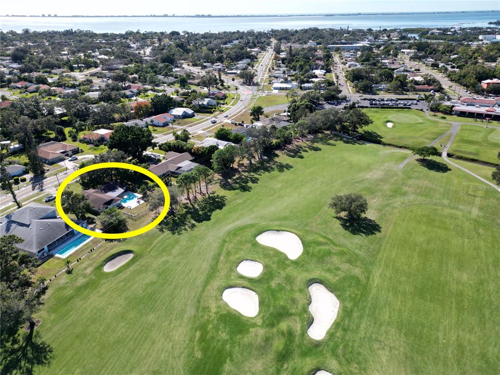 An aerial view shows a house with a pool situated next to a golf course — 433 WHITFIELD AVENUE, SARASOTA, FL