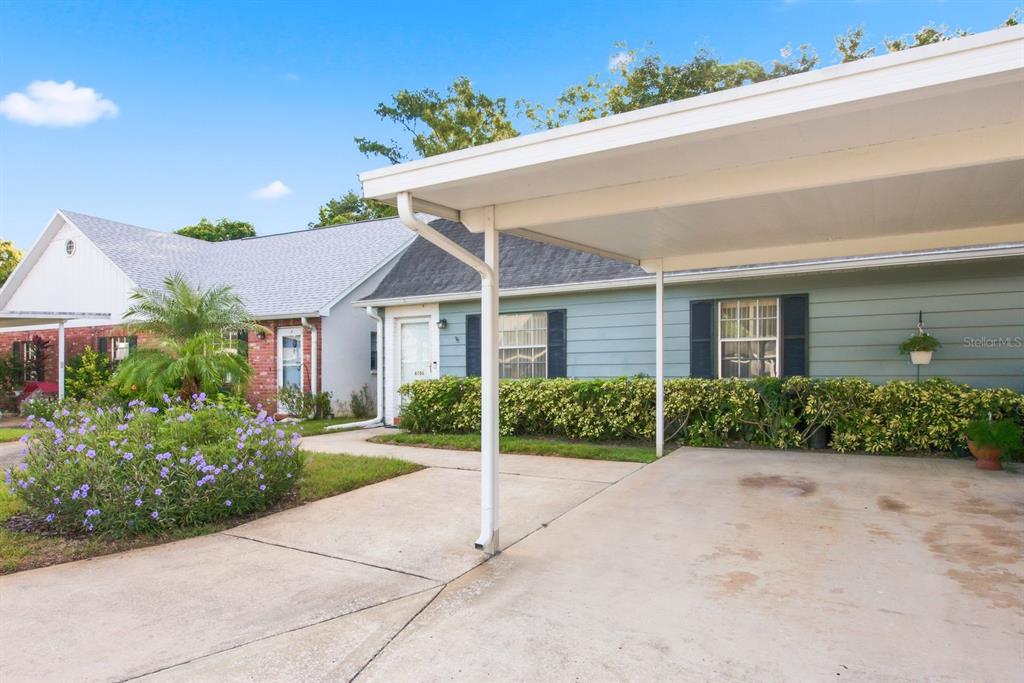 A single-story house with a carport, light blue siding, and a concrete driveway — 6206 WILDS DRIVE UNIT 5A, NEW PORT RICHEY, FL
