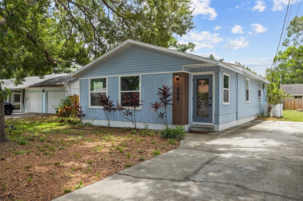 A light blue single-story house with a concrete driveway and a detached two-car garage — 1008 37TH STREET W, BRADENTON, FL